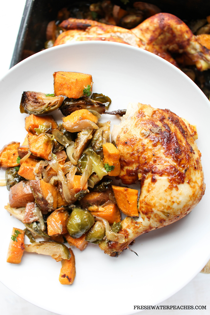 White plate with easy bbq chicken and roasted vegetables.