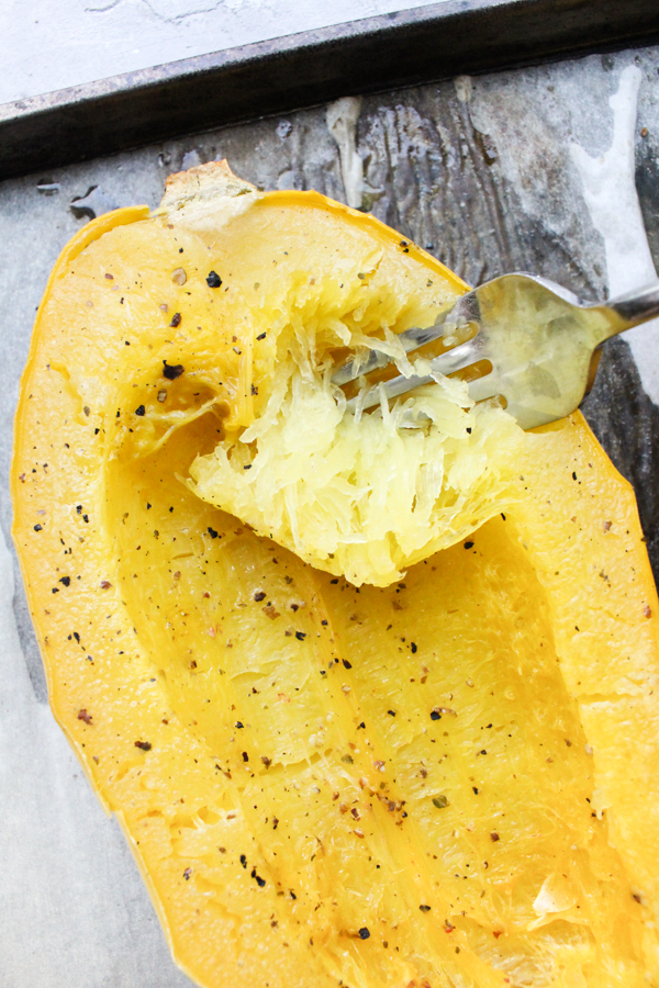 How to cook spaghetti squash step 7 - scrape the edges with a fork to fluff up the spaghetti.