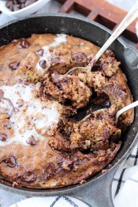 Healthy banana cookie skillet with two spoons scooping out a bite.