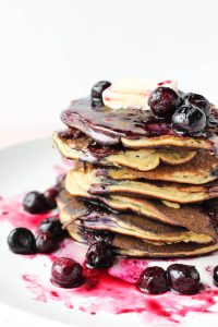 Stack of pancakes with blueberries on top.