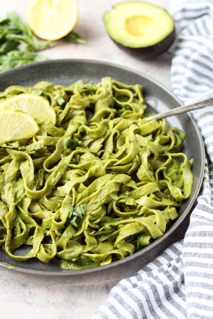 Plate of fettuccine tossed in pesto.