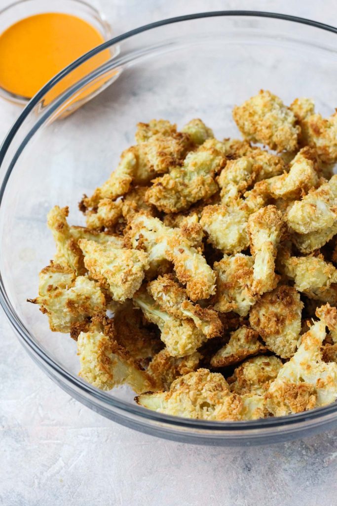 Crispy cauliflower in bowl before being coated with buffalo sauce.