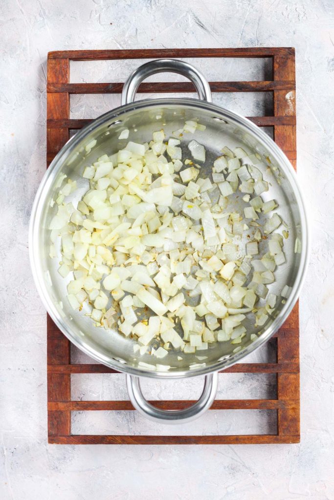 Onions and garlic sautéing in pot.