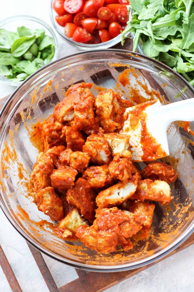 Chicken pieces tossed in tomato sauce.