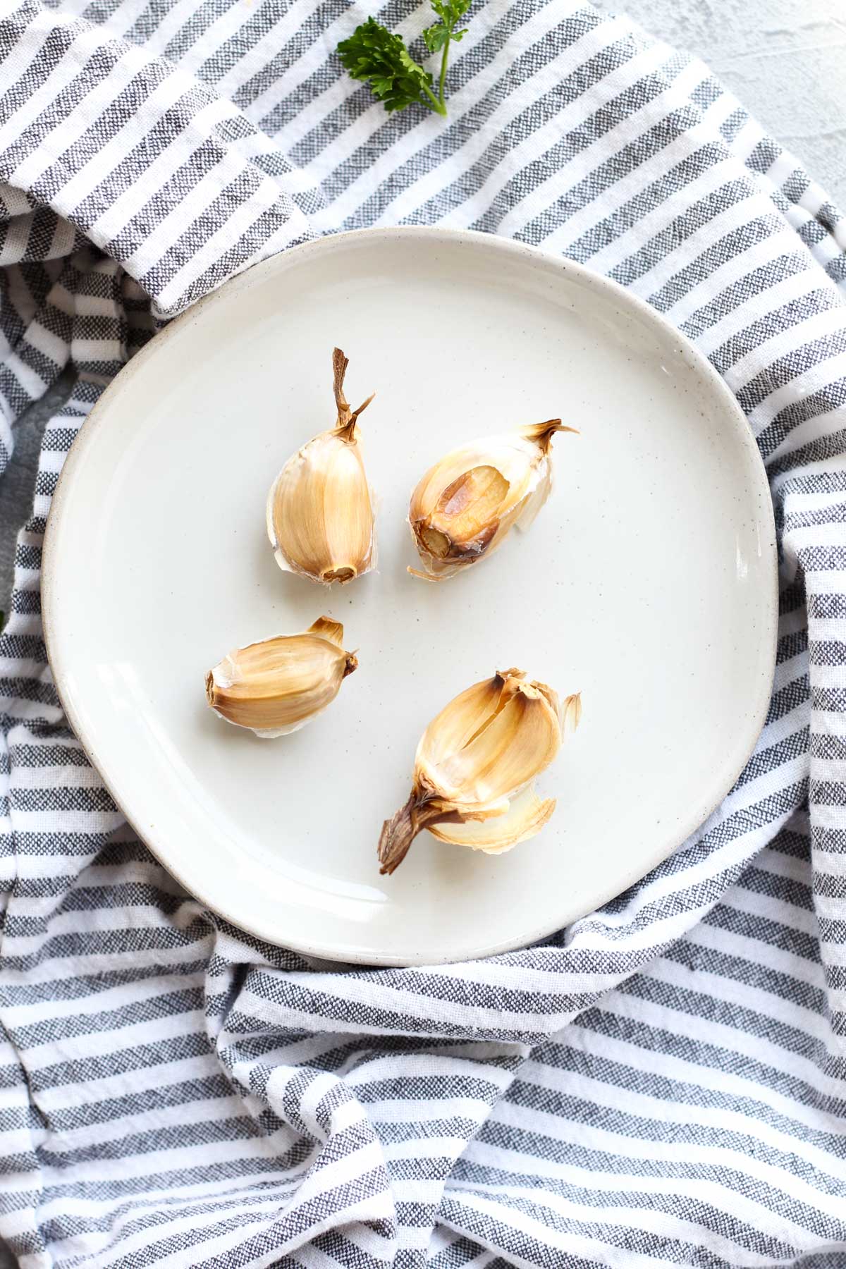 Roasted garlic on a white plate.