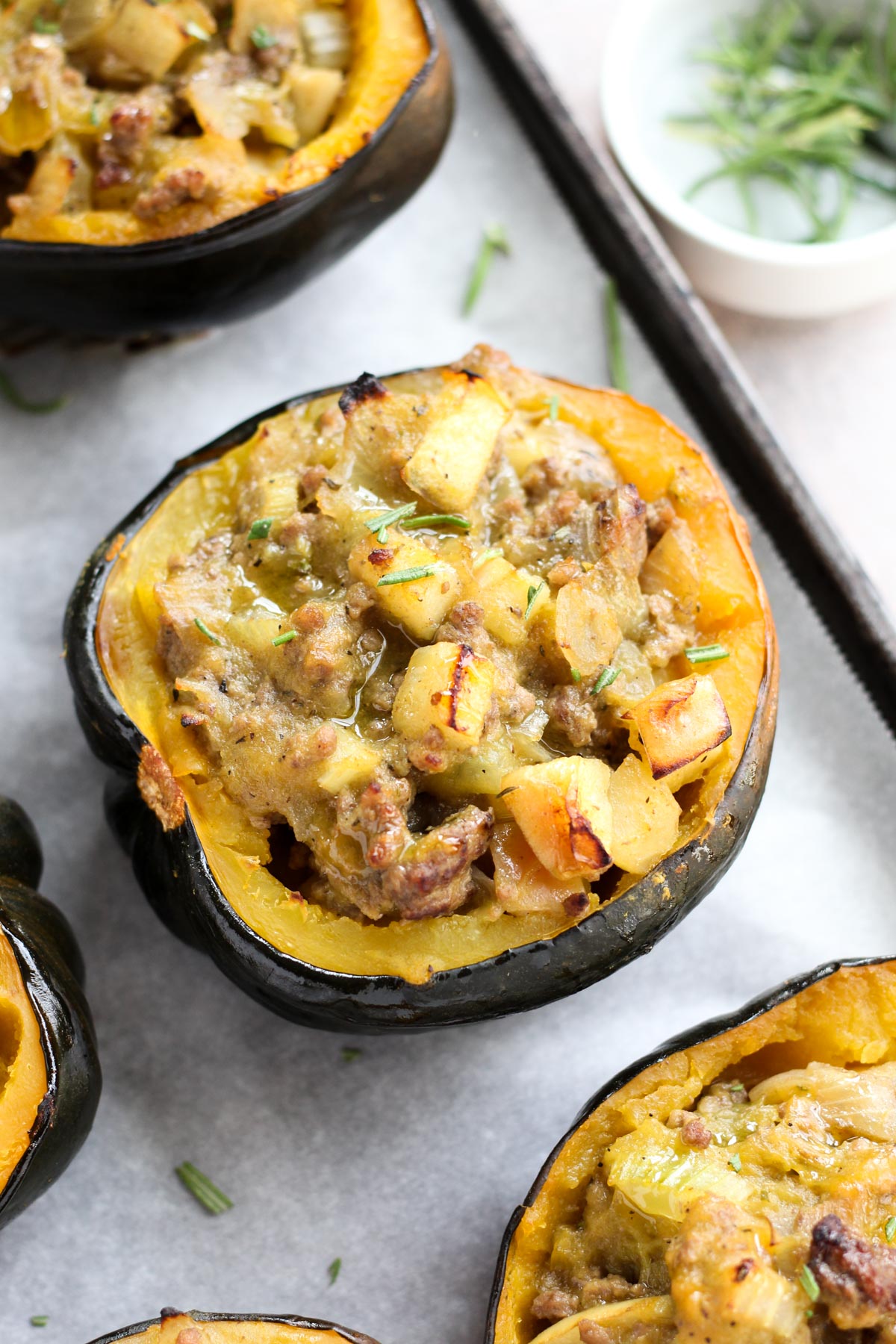 Baking sheet with stuffed acorn squash.