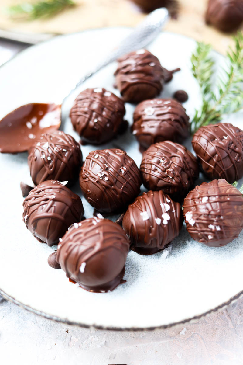 White plate with dark chocolate peppermint truffles.