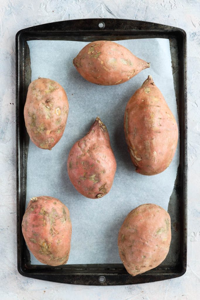Sweet potatoes on a baking sheet.