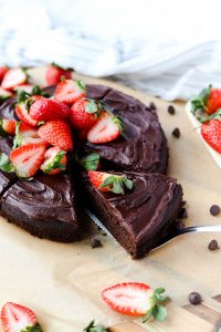 Chocolate cake with strawberries on top.