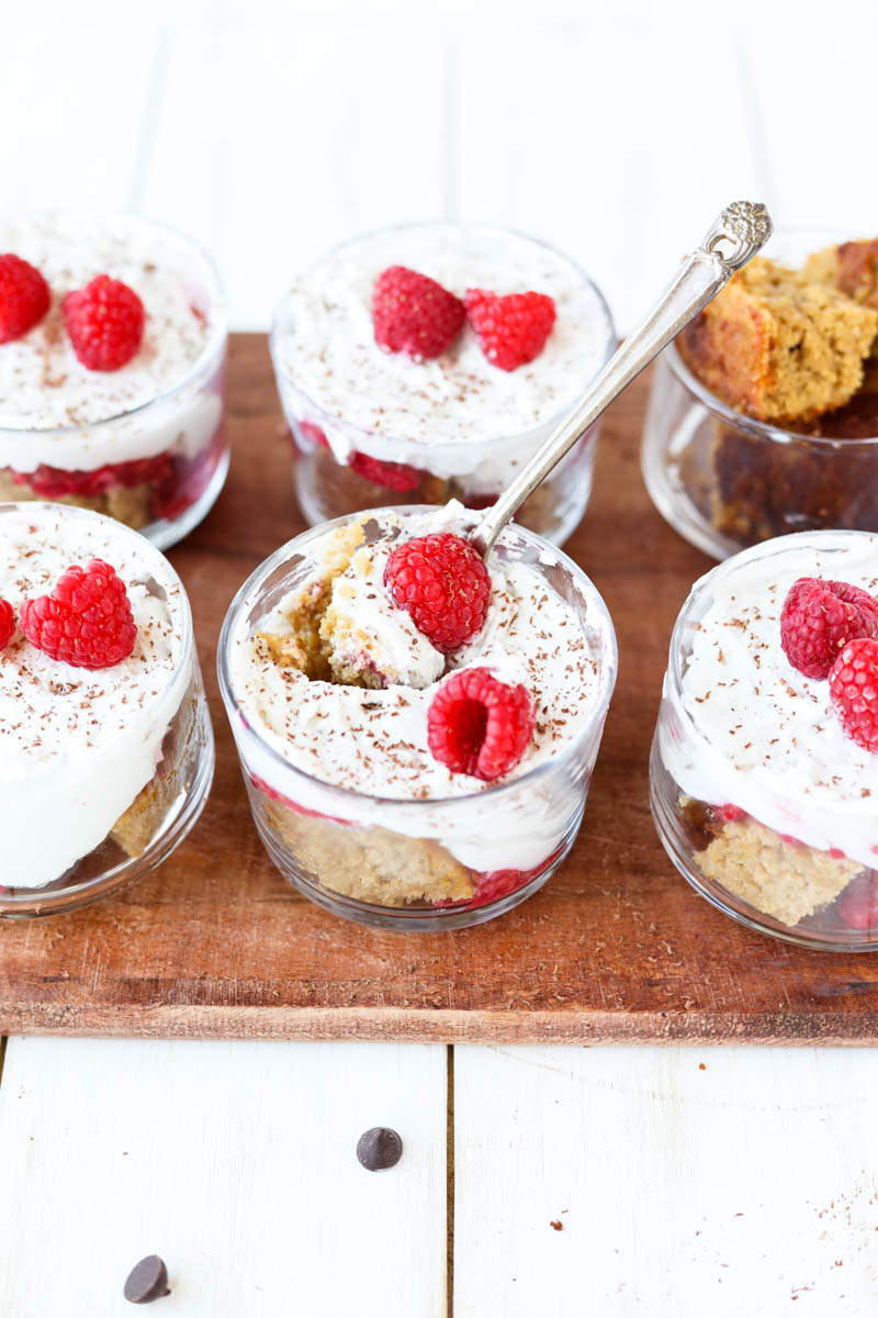 Raspberry trifle with spoon scooping out a bite.