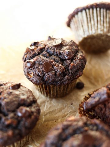 Chocolate banana muffins on parchment paper.