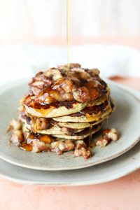 Syrup dripping on bananas foster pancakes.