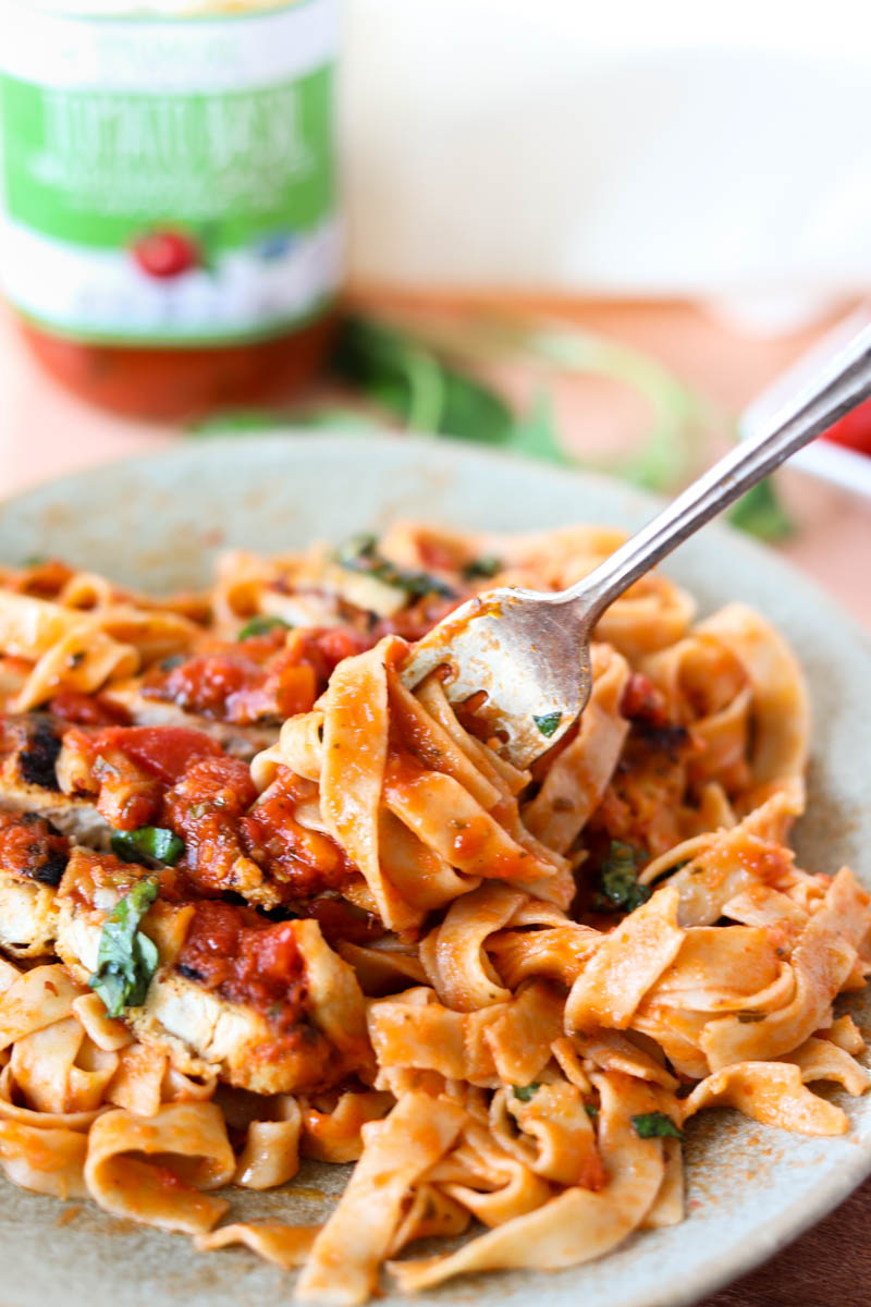 Fork with sauce and fettucine and chicken cutlets.