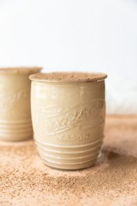Coffee milkshake with cocoa powder sprinkled on top.