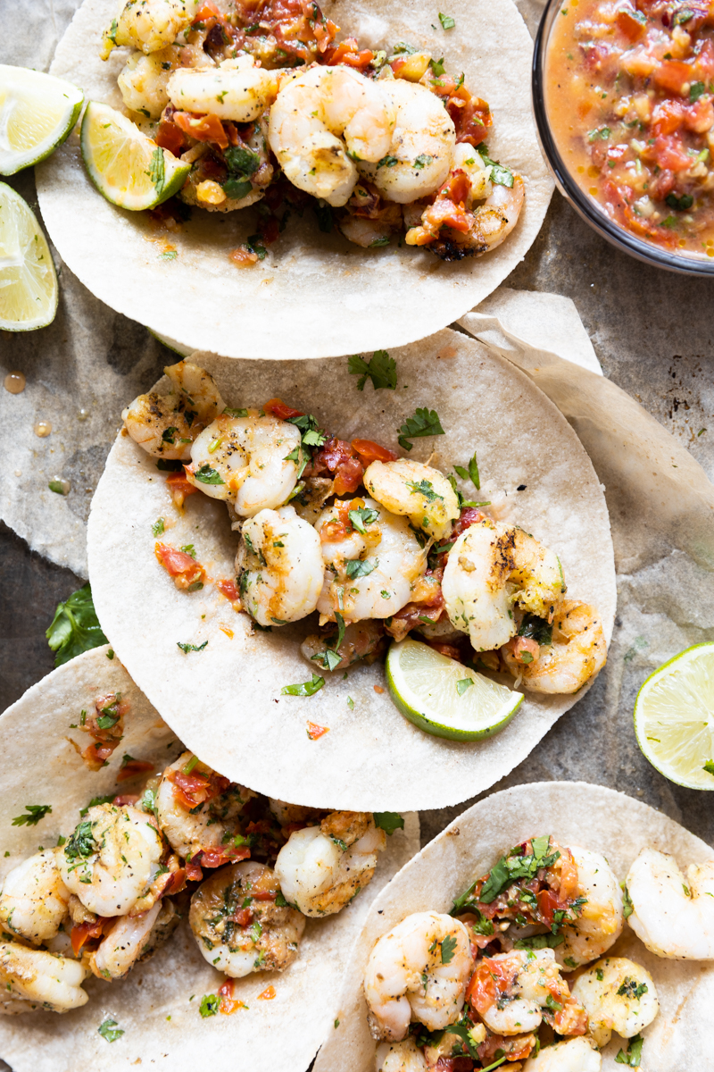 Close up picture of grilled shrimp tacos on a baking sheet.