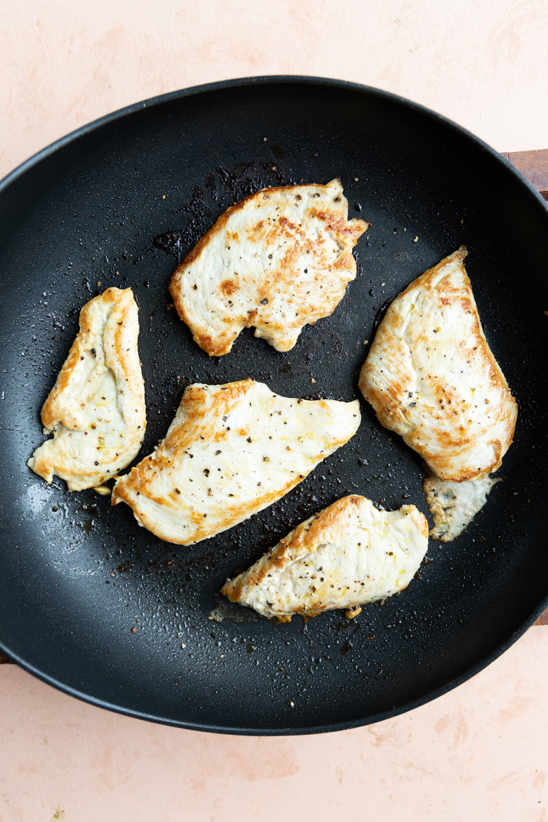 Cooked chicken breast in skillet.