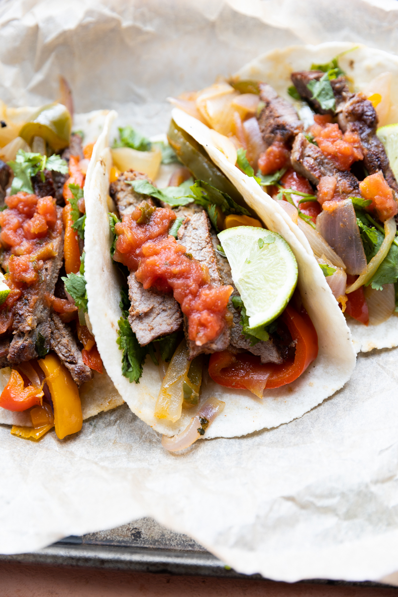 Tacos with salsa drizzled on top.