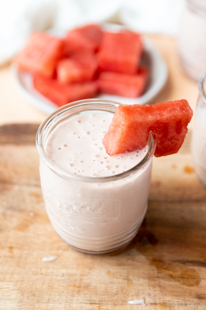 Watermelon Banana Smoothie in clear glass cup.