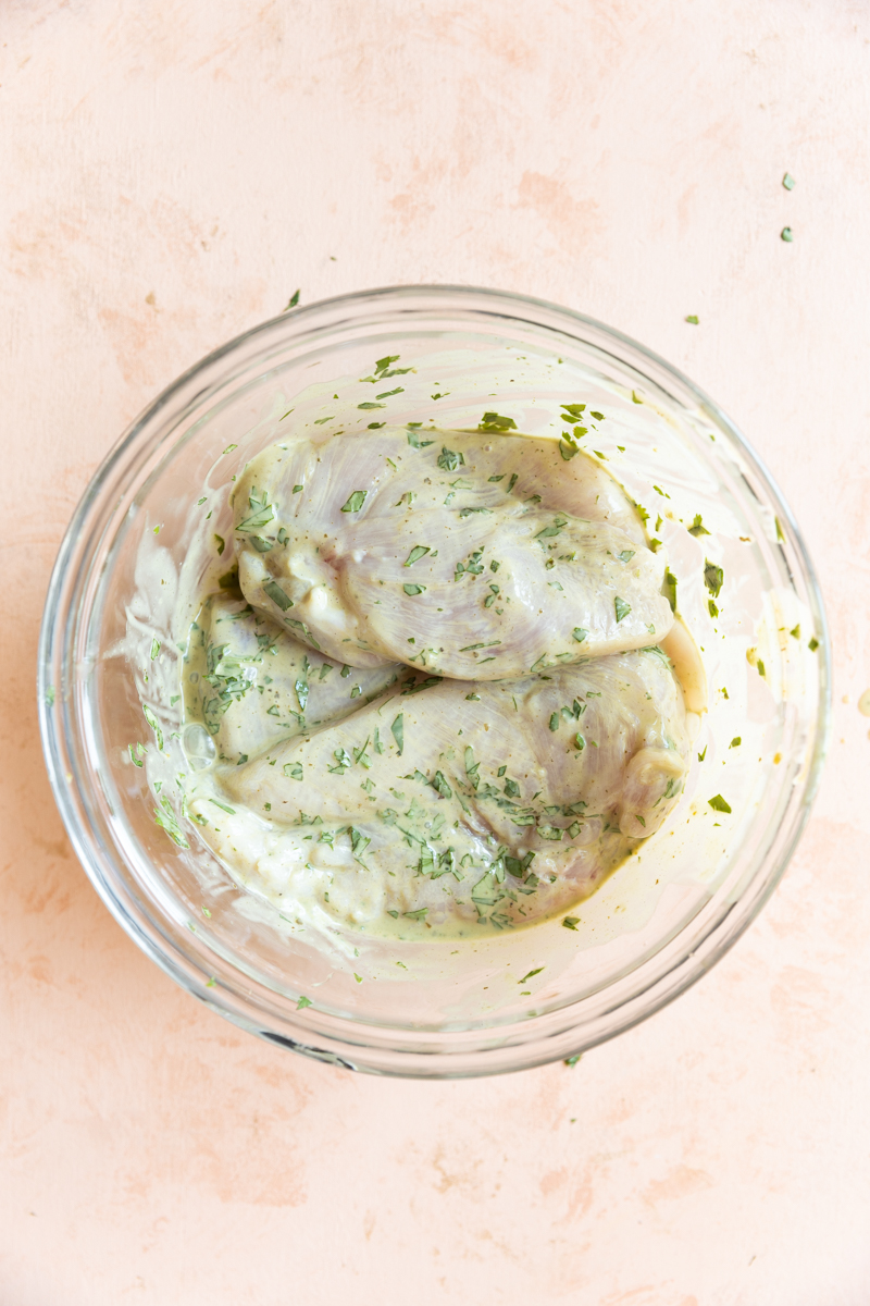 Chicken marinating in cilantro lime dressing.