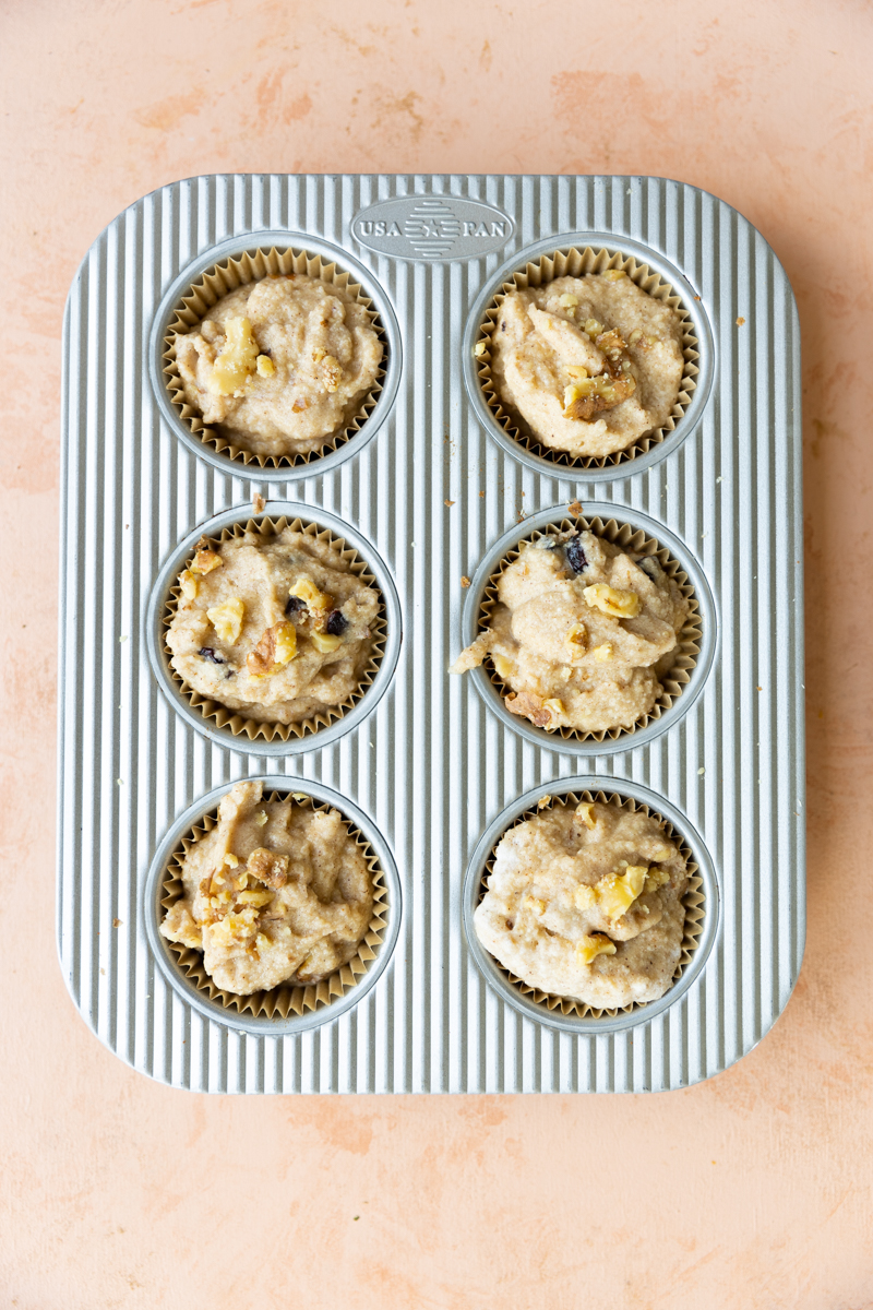 Muffins before baking in metal muffin tin.
