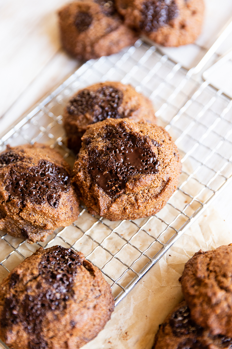 Pumpkin chocolate chip cookies on a metal rack.