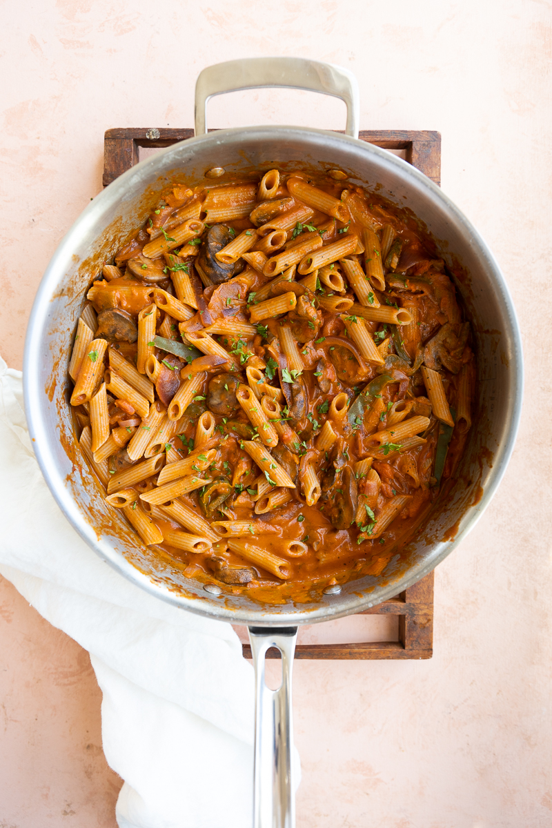 Cooked vegetables with pasta and tomato sauce in large skillet.