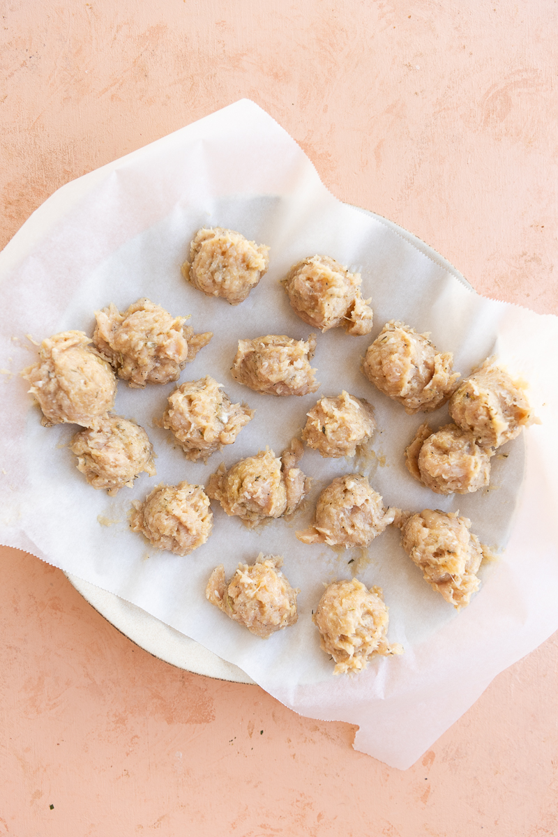 Chicken meatballs on parchment paper.