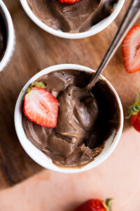Spoon scooping out thick chocolate mousse.
