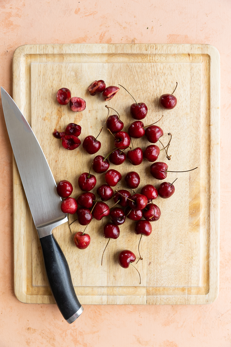 Cherries on a cutting board.