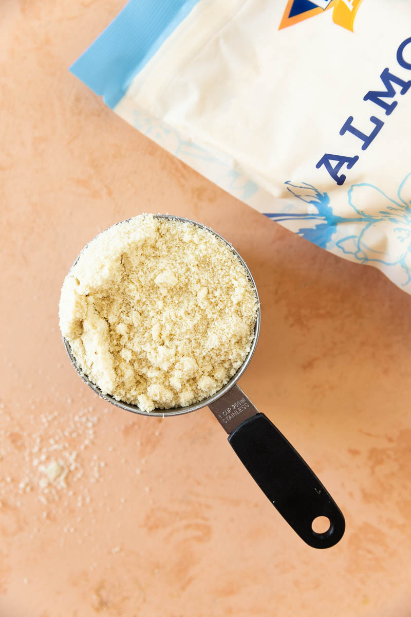 A measuring cup filled with almond flour.