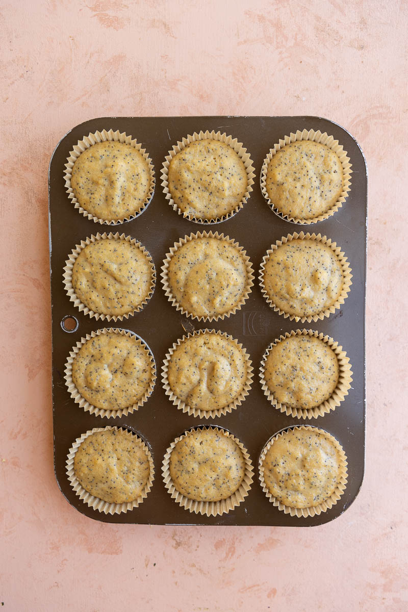 Lemon cupcake batter in 12 cupcake tins.