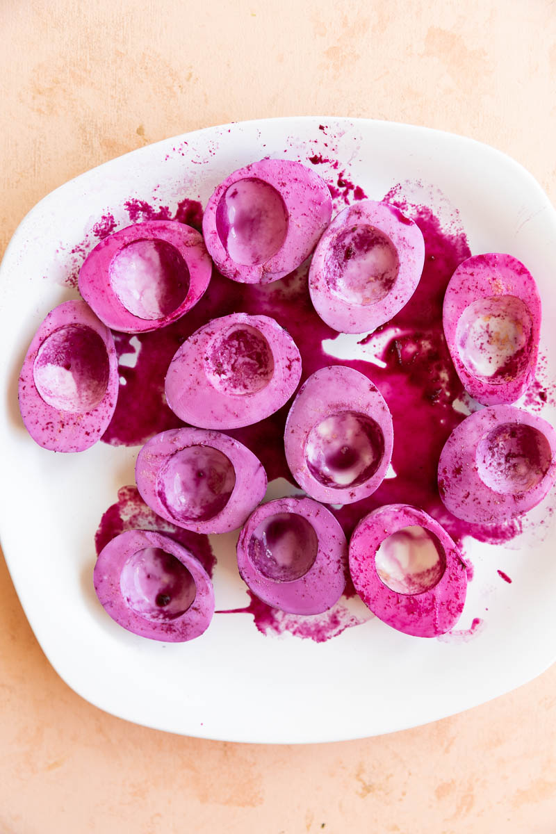 Pink dyed eggs on a plate.