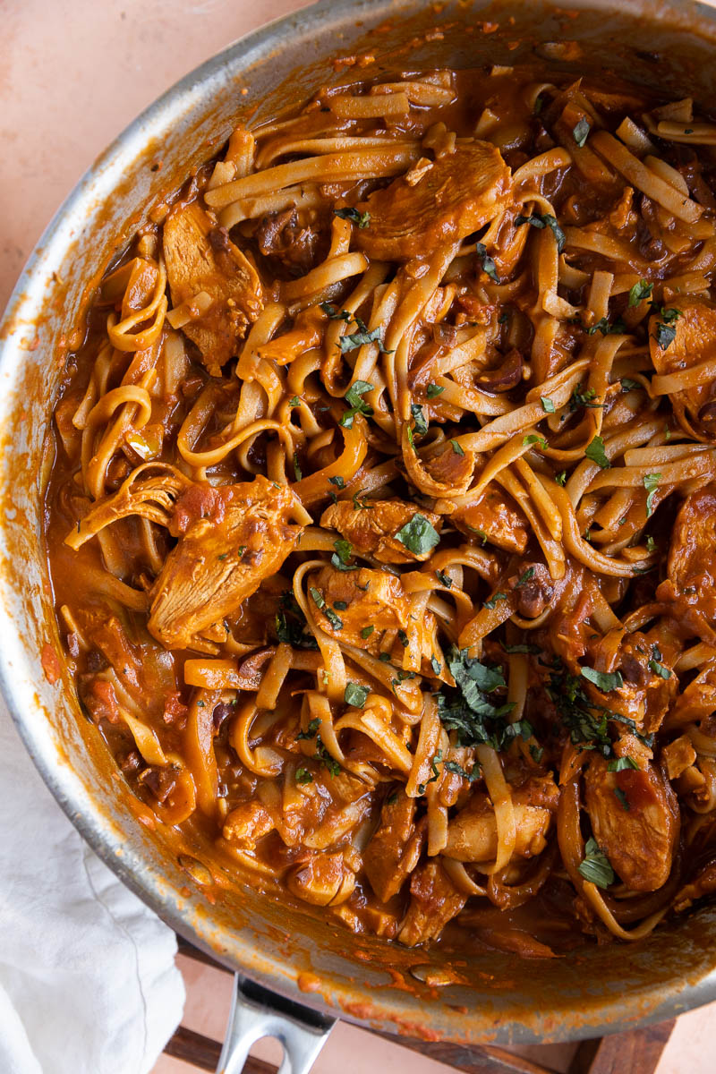 Spicy chicken pasta twirled on a fork.