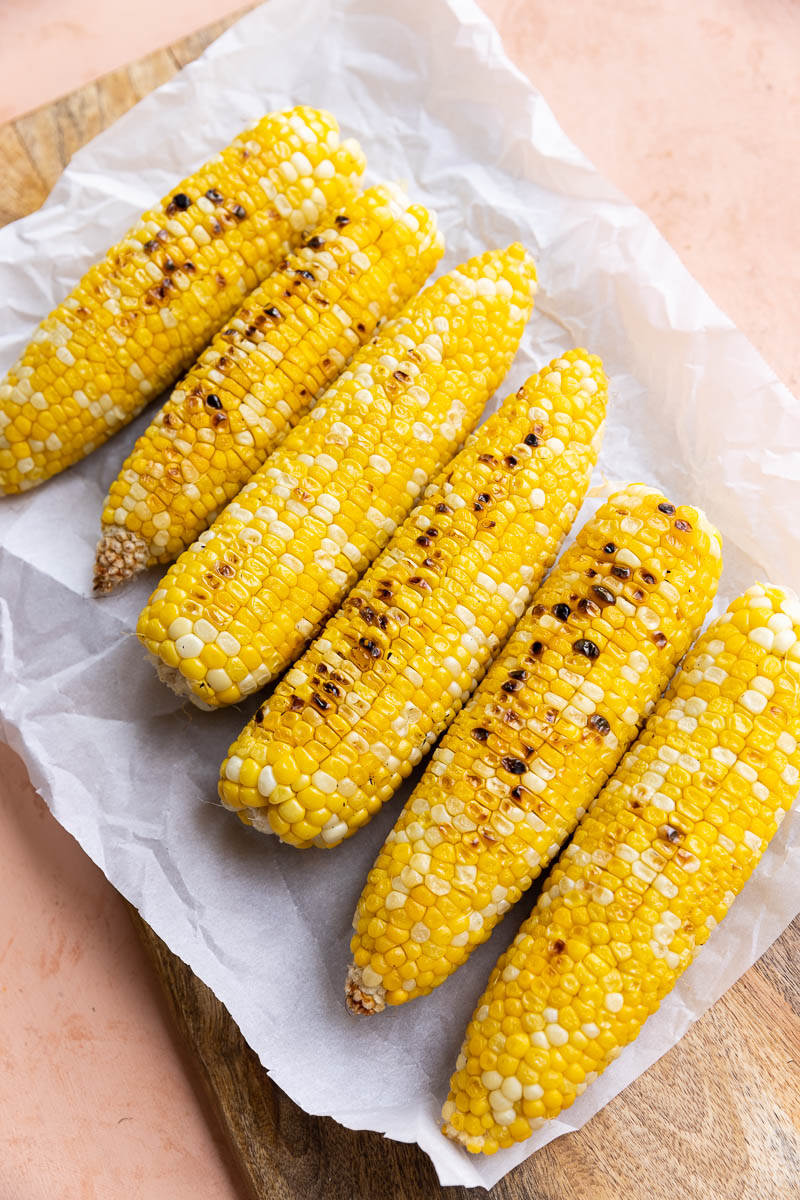 Grilled corn on parchment paper.