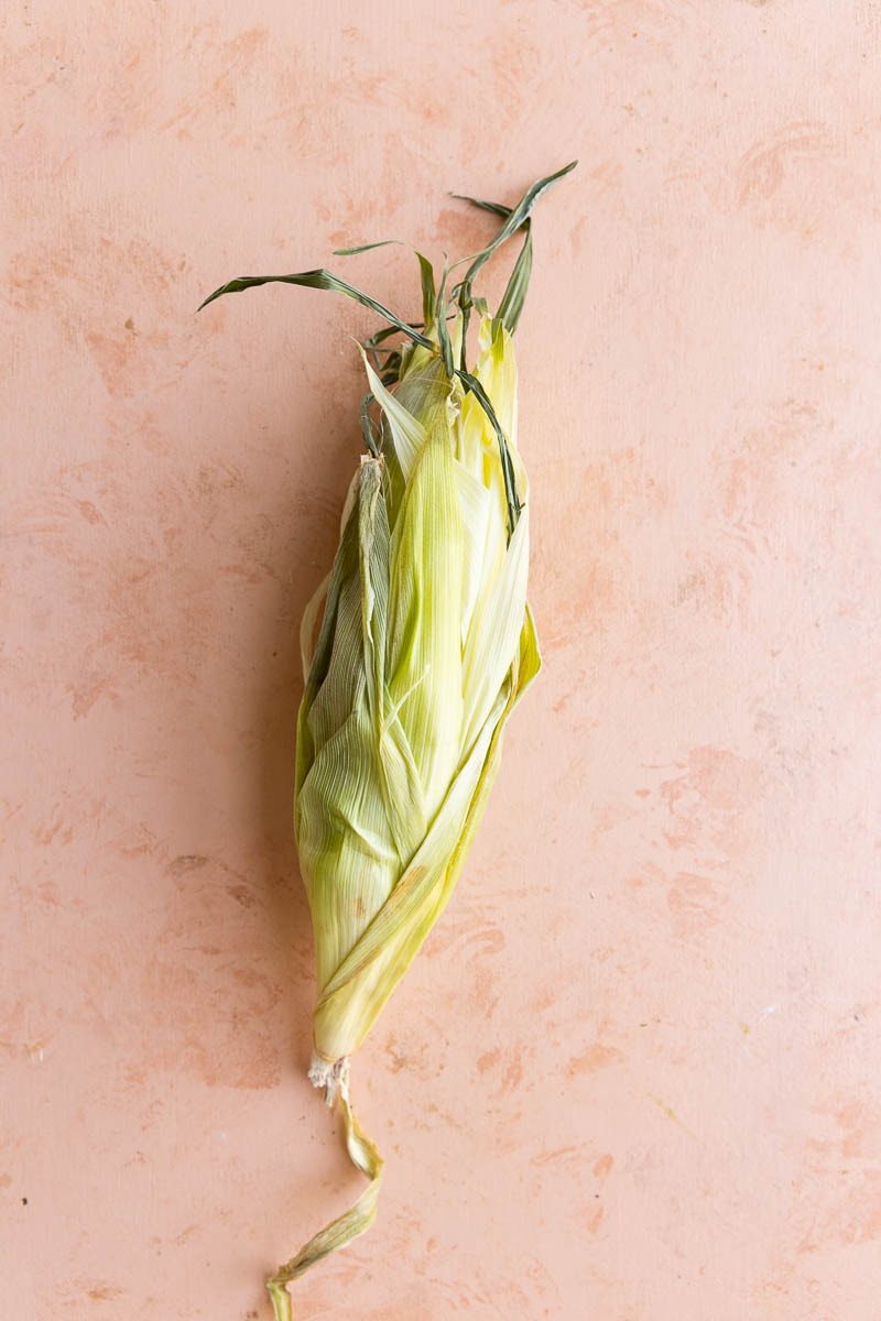 Corn with husk peeled back up.