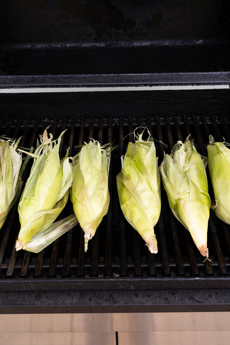 Corn on the cob cooking on the grill.