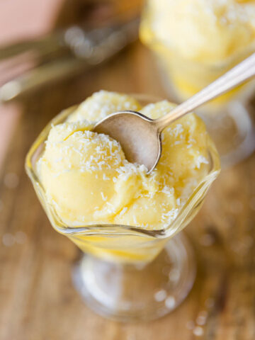 Spoon scooping out pineapple sorbet.
