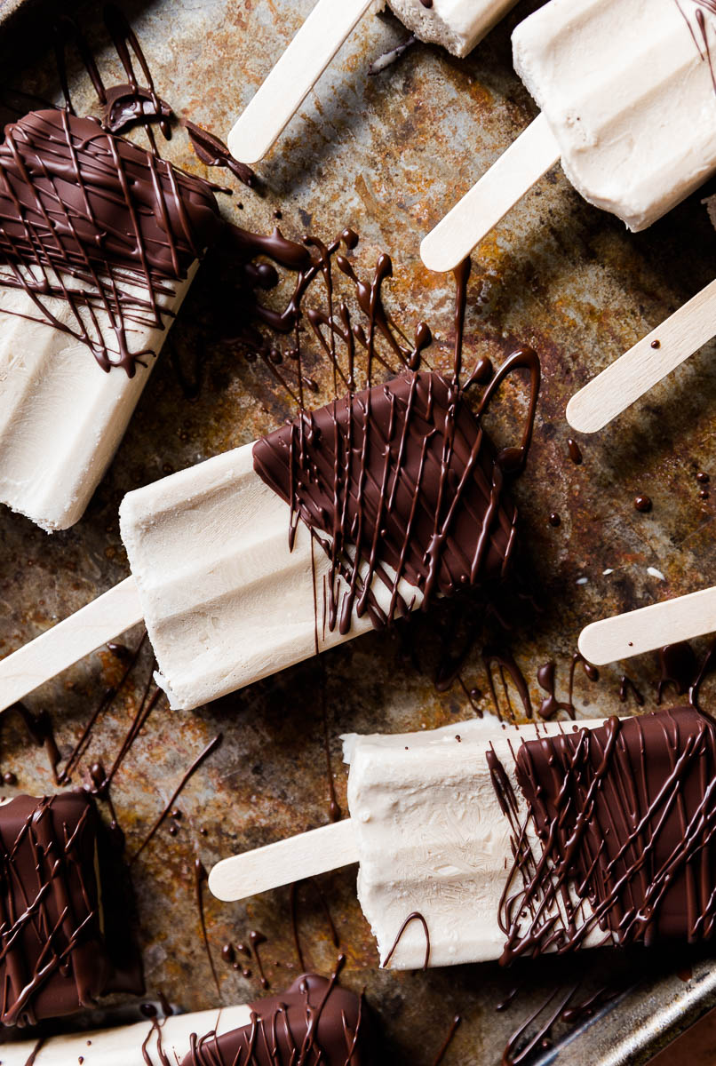Popsicles with chocolate drizzled on top.