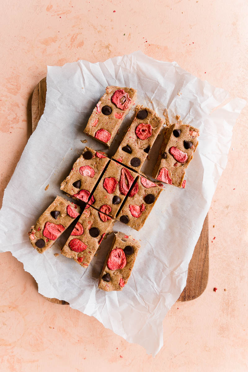 Strawberry protein bars cut on parchment paper.