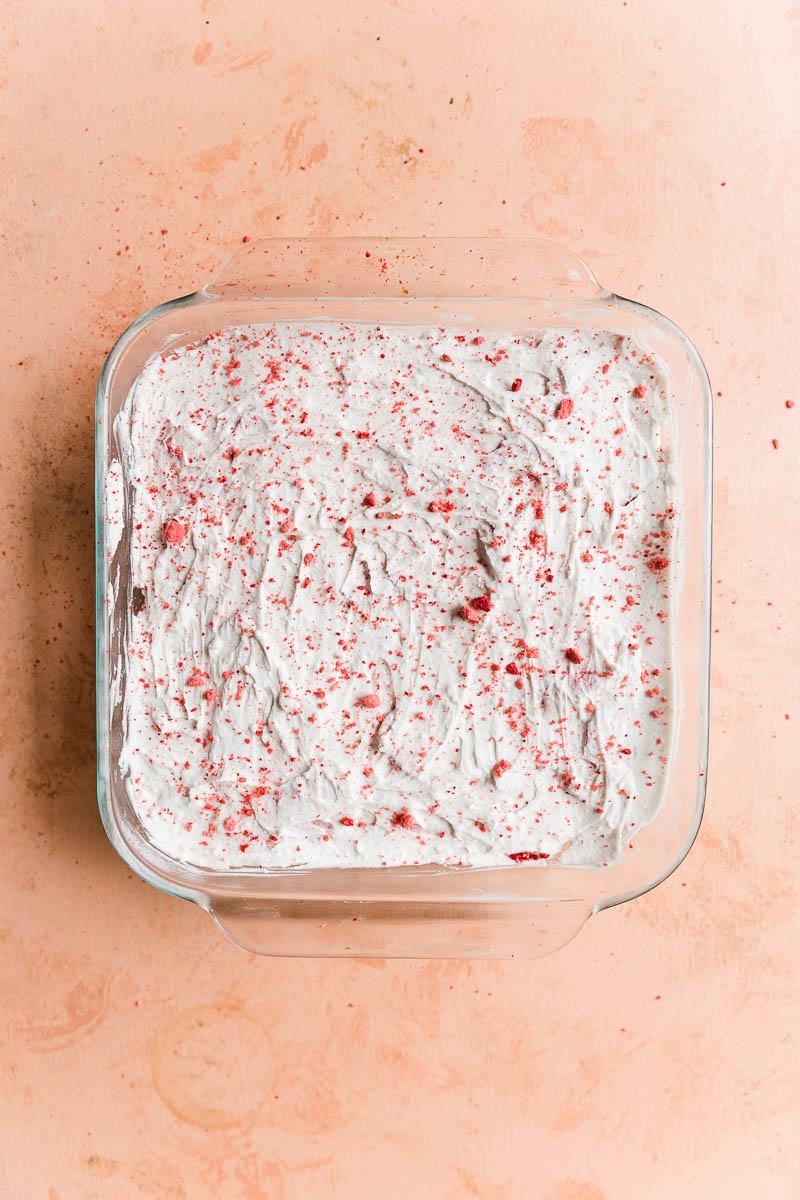 Whipped cream on top of strawberry bars.