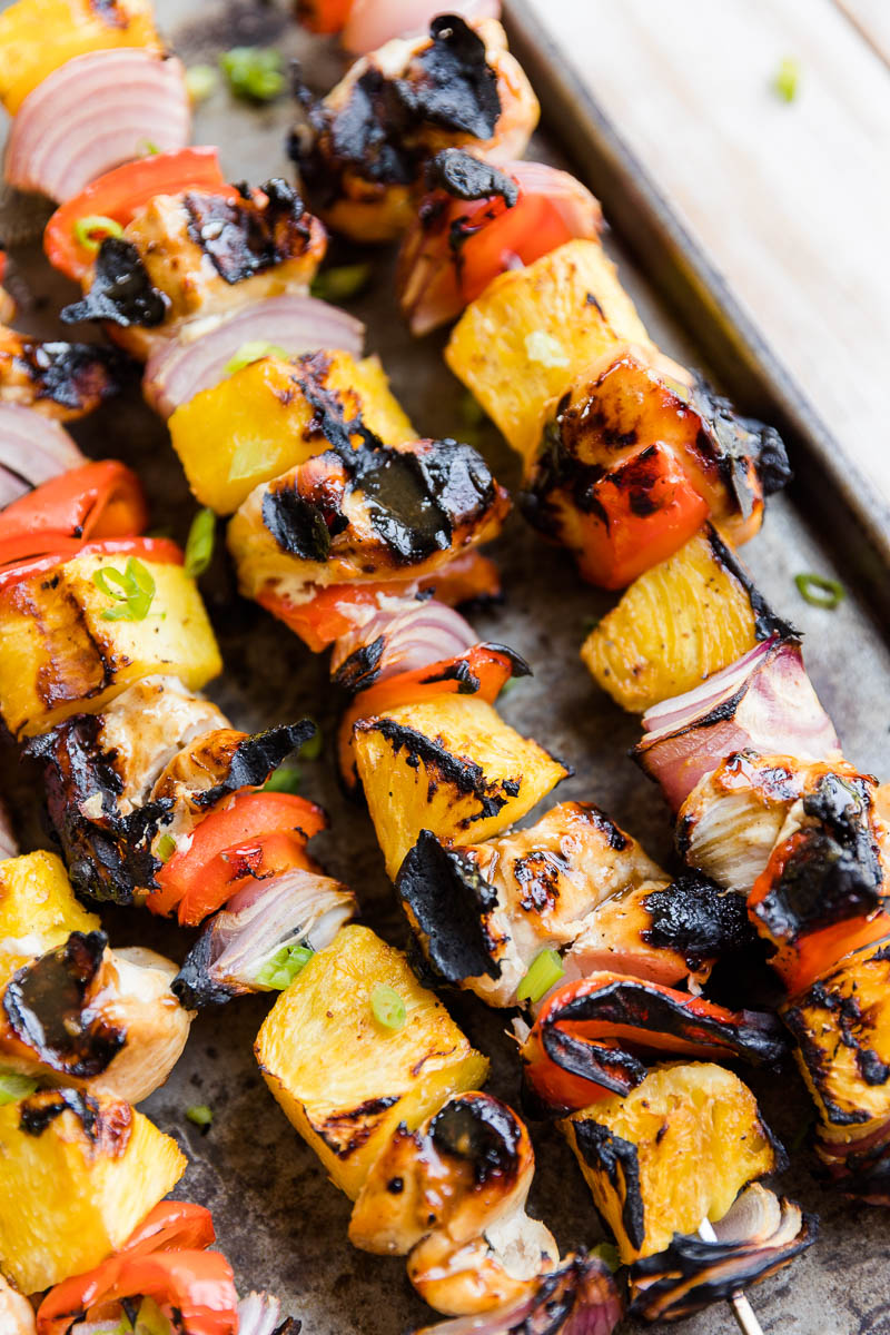 Close up picture of teriyaki chicken skewers with pineapple and veggies.