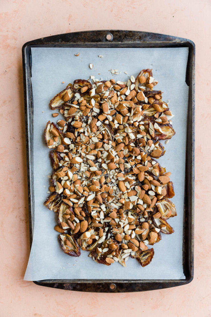 Pitted dates with chopped almonds sprinkled on top.