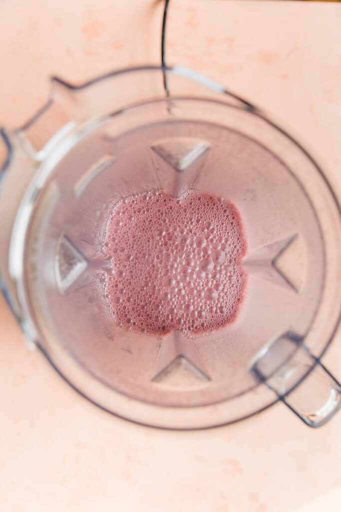 Cherry ice cream ingredients mixed in blender.