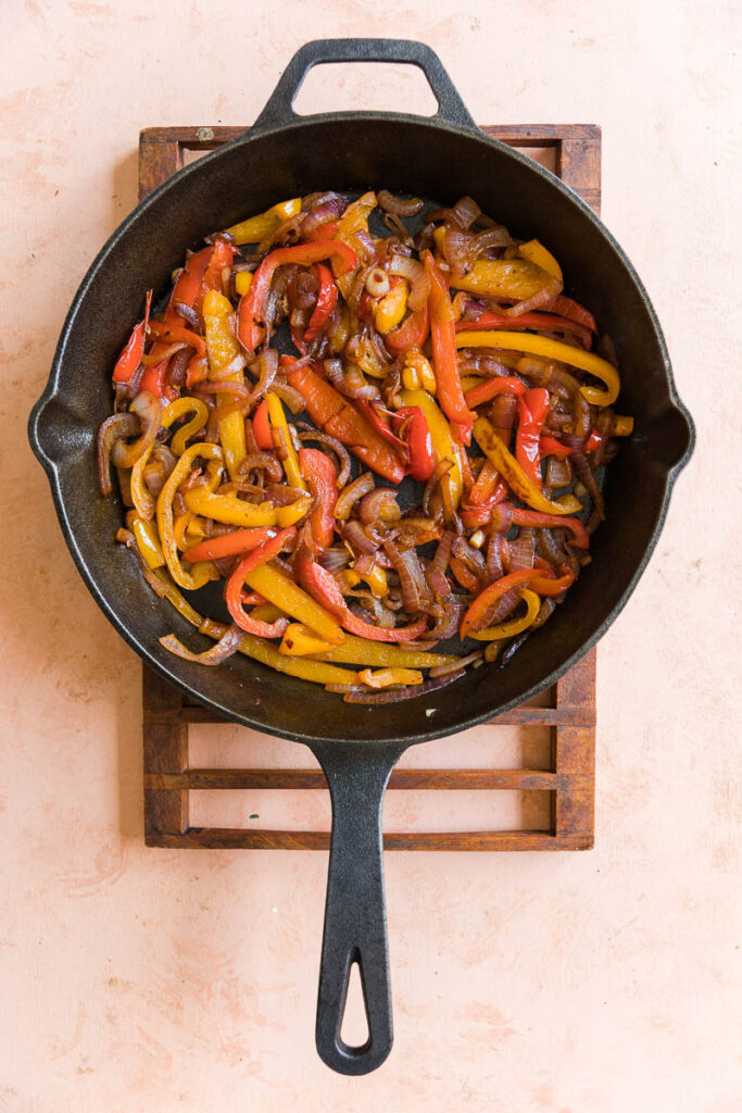 Cooked onions and peppers in cast iron skillet.