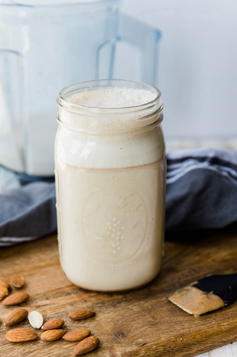 Homemade frothy almond milk in a large mason jar.