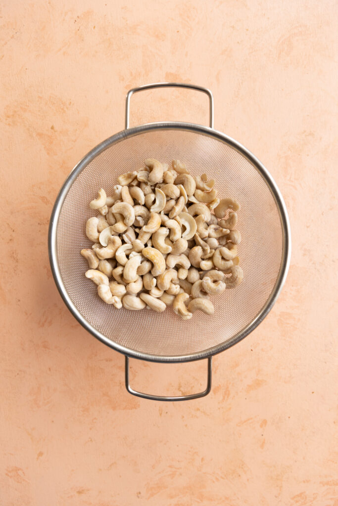 Drained cashews in strainer.