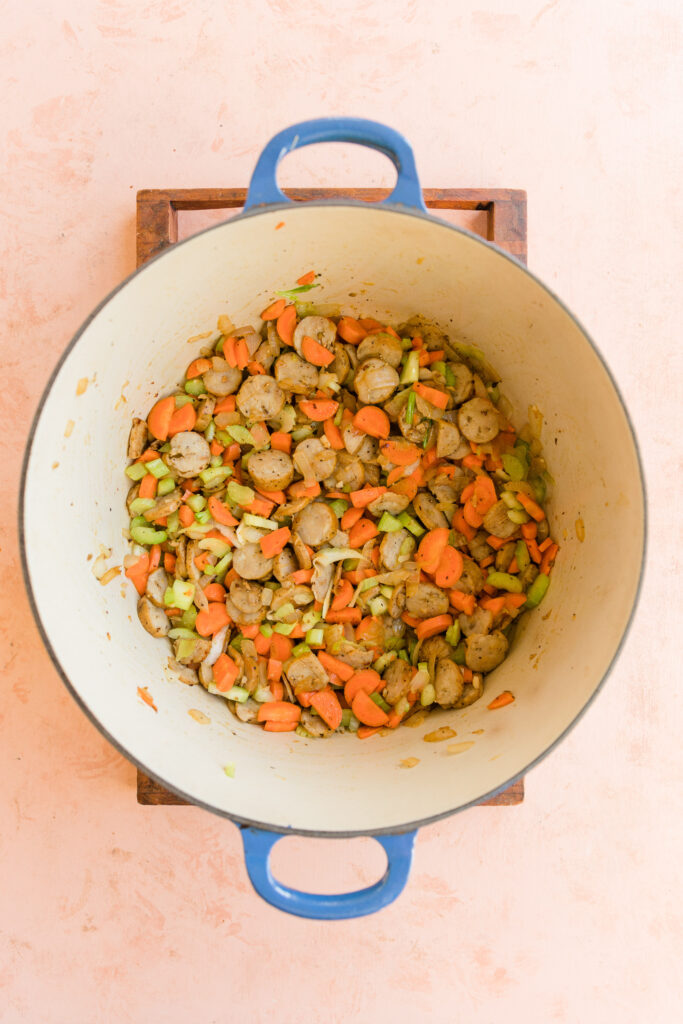 Chicken sausage and all vegetables cooking in large pot.