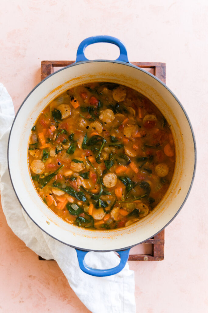 Finished soup in large pot with baby spinach stirred in.