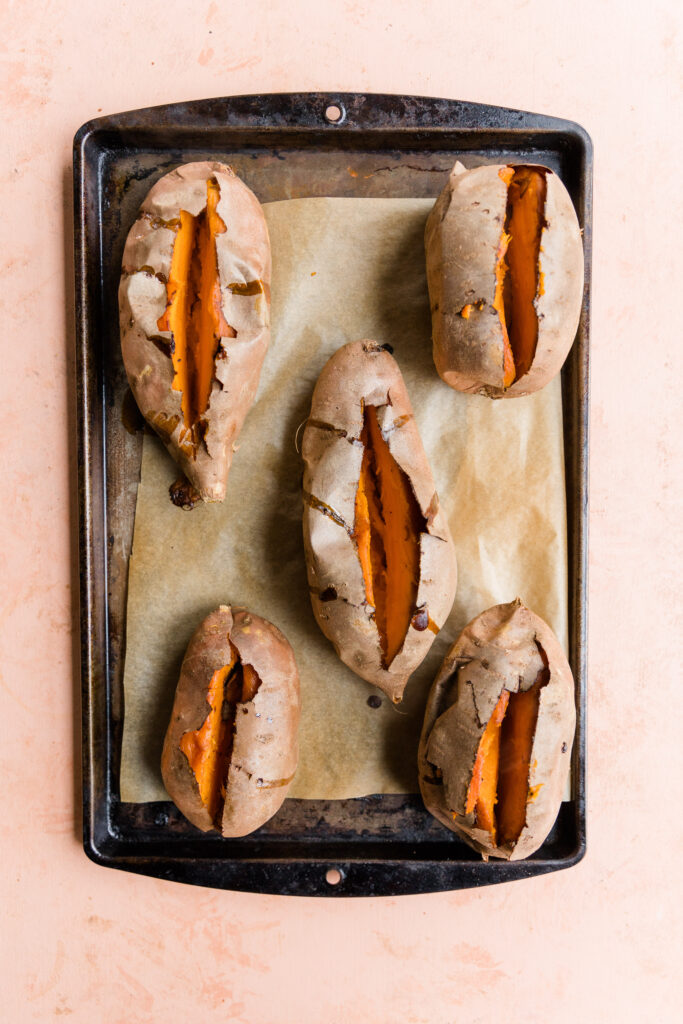 Baked potatoes cut open the long way.