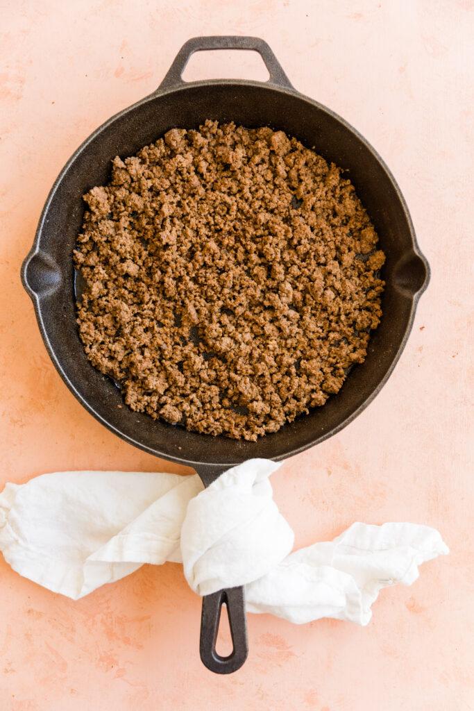 Cooked ground beef in a cast iron skillet.